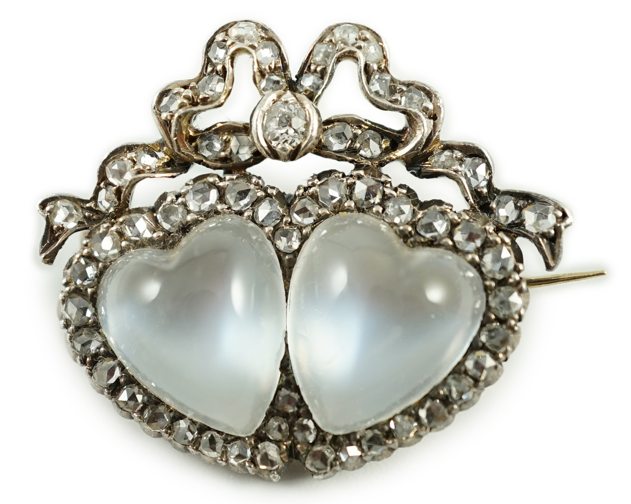 An Edwardian gold and silver, moonstone and diamond cluster set twin hearts brooch